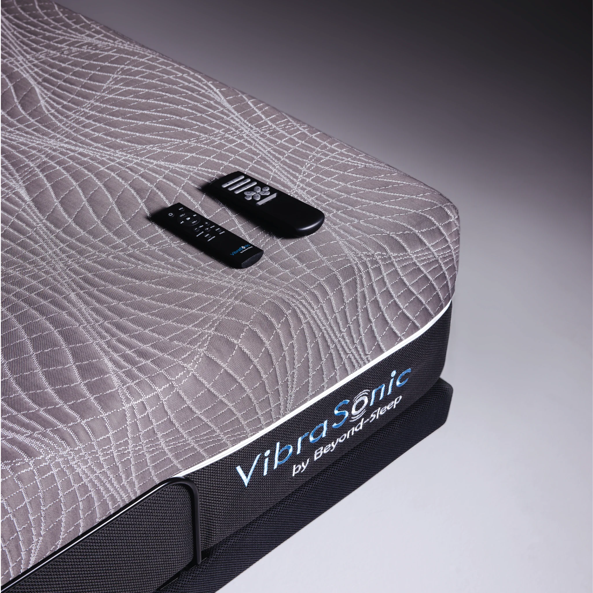 close up of Vibrasonic mattress with remotes