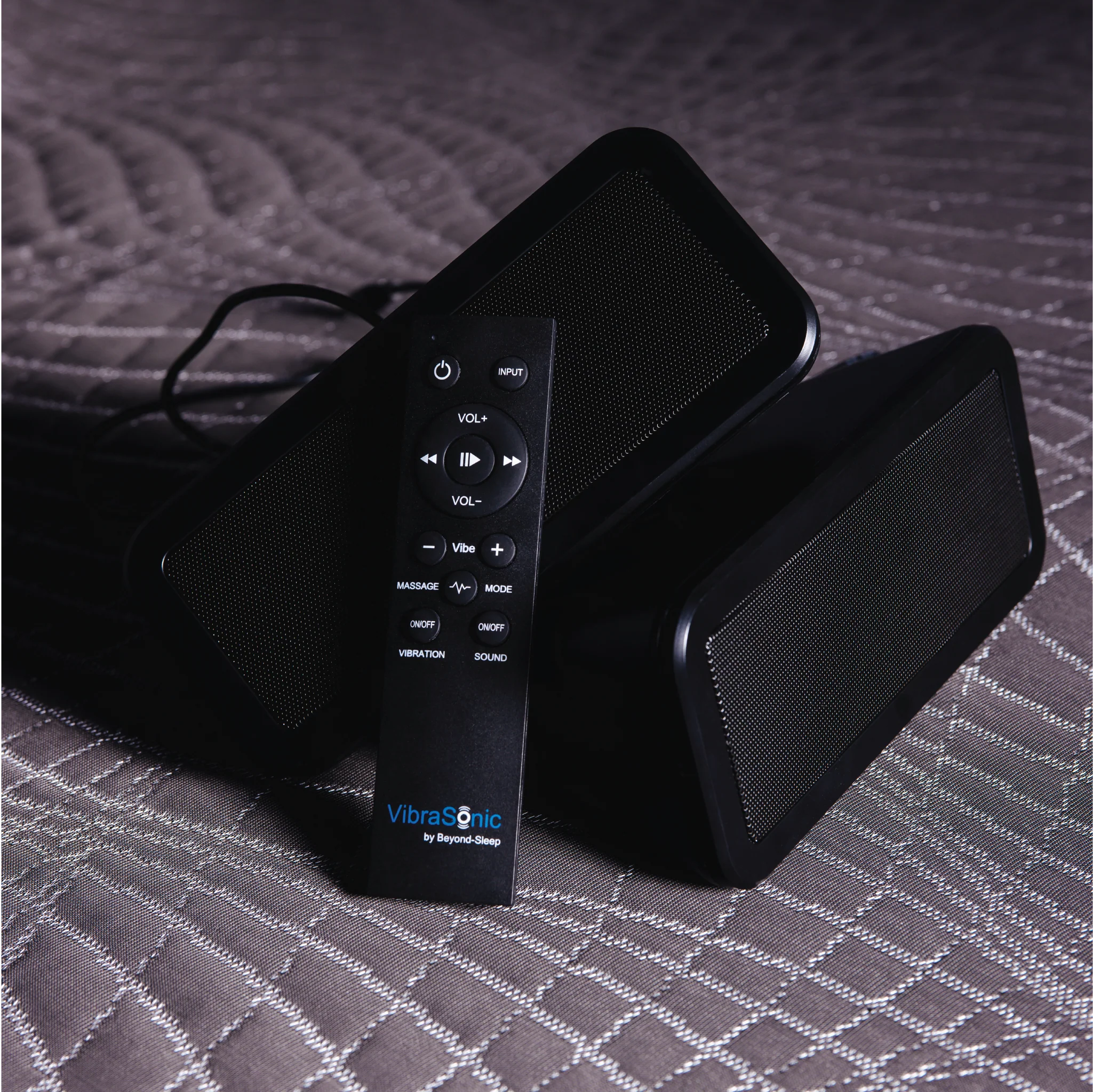 close up of Vibrasonic mattress with satellite speakers and remote